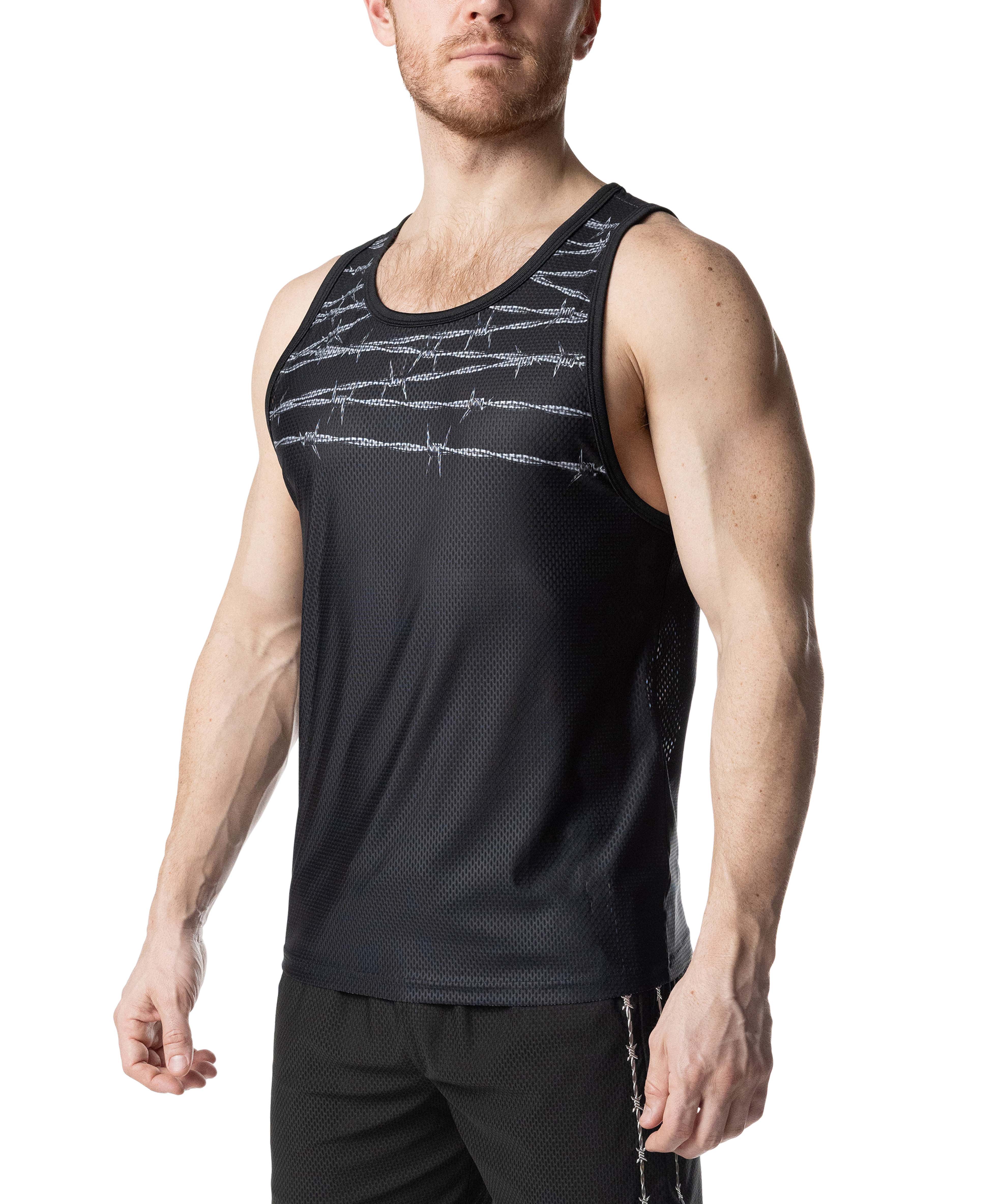 Man wearing a black tank top with barbed wire design on a white background