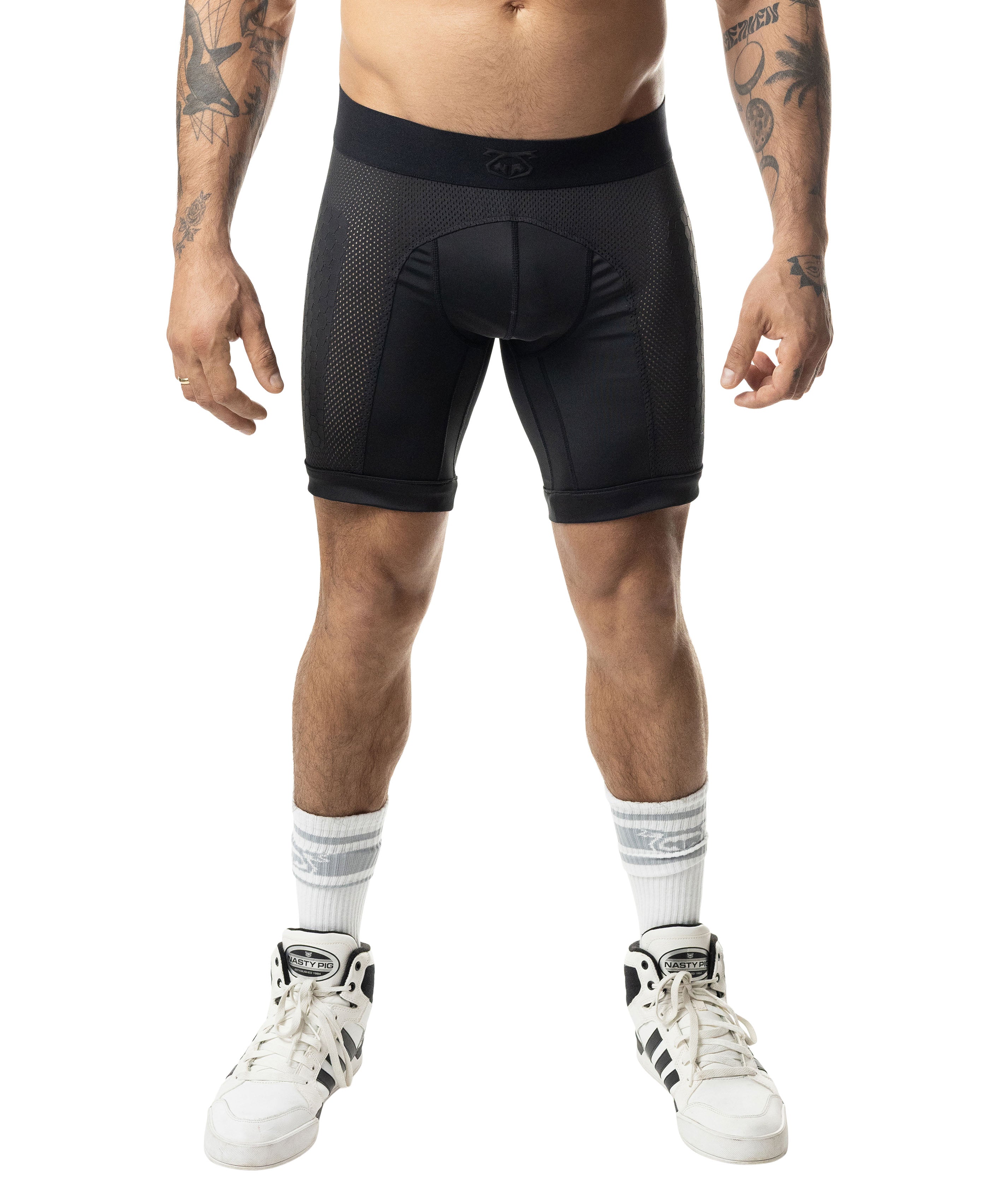 Person wearing black athletic shorts on a white background