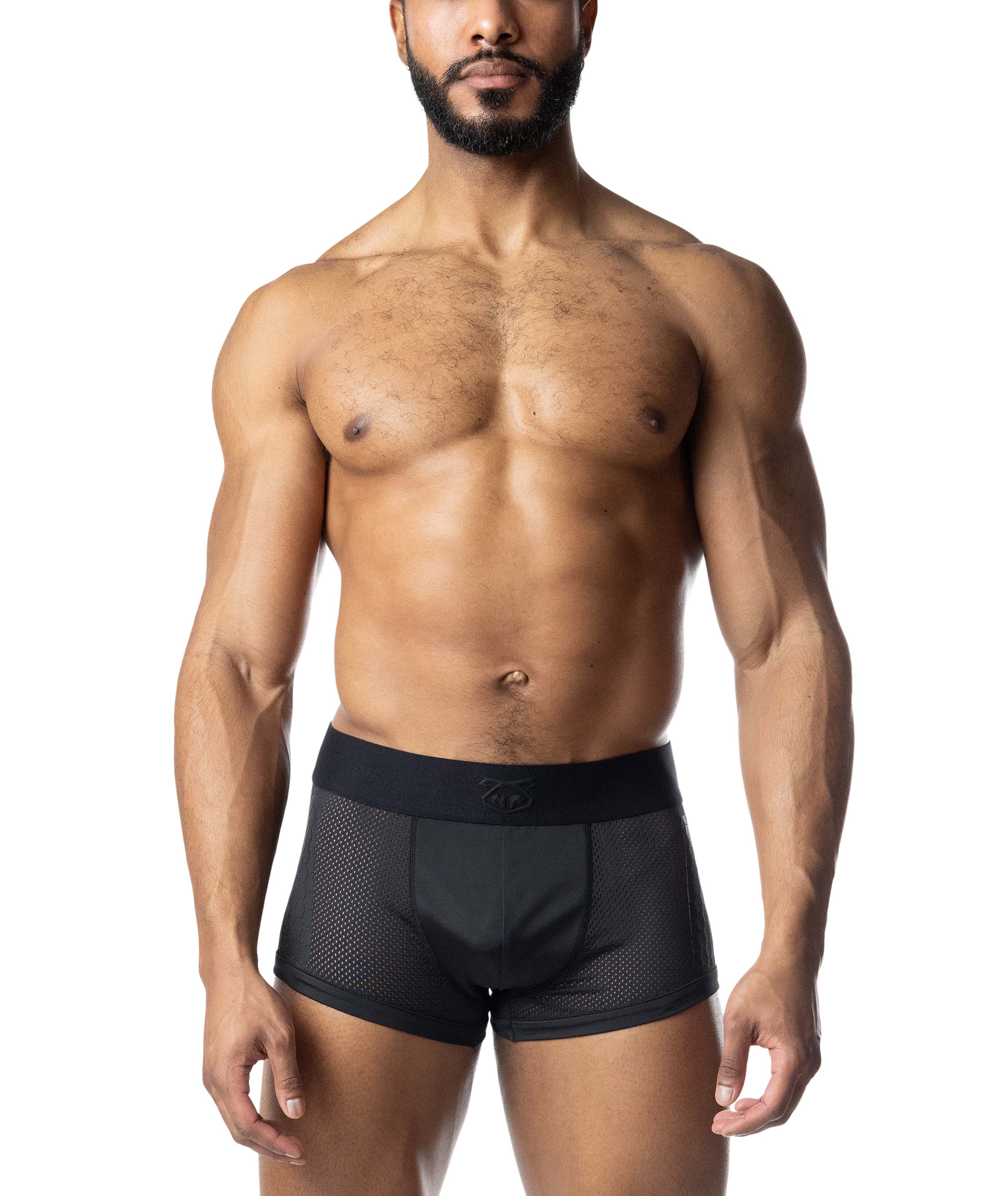 Man wearing black compression briefs on a white background