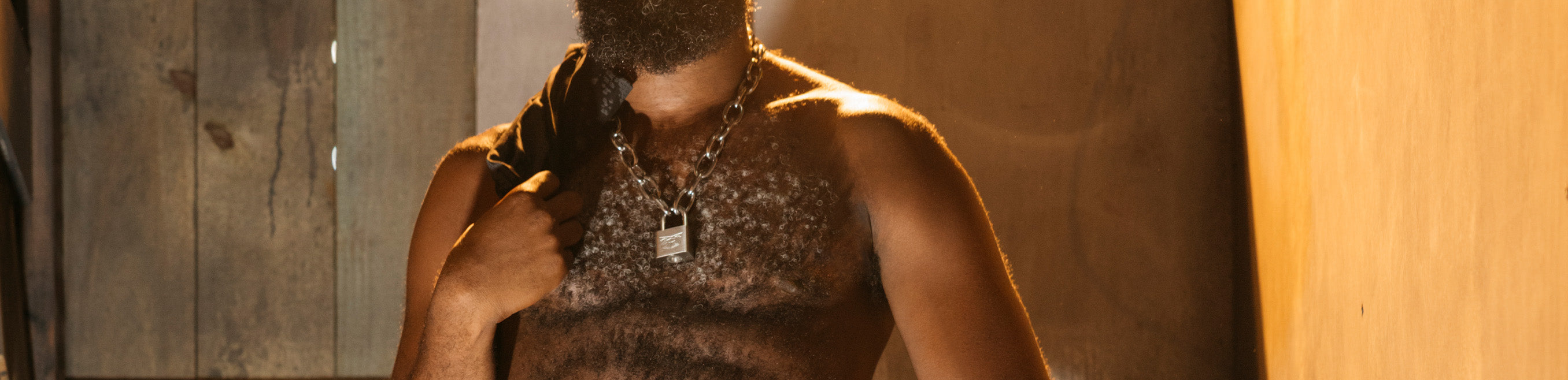 Two men embracing, Nasty Pig jewelry is visible