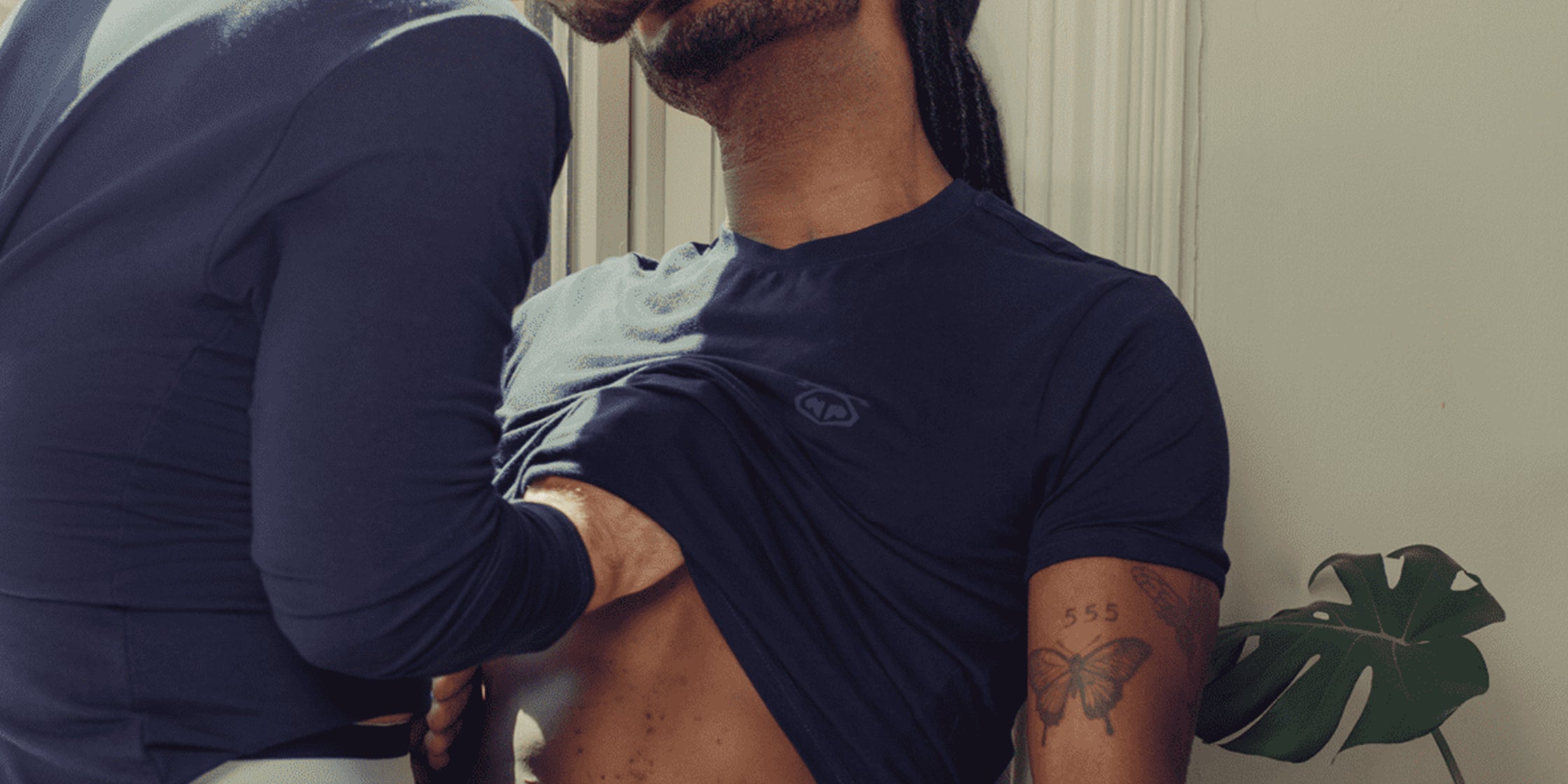 Two men kissing in bed