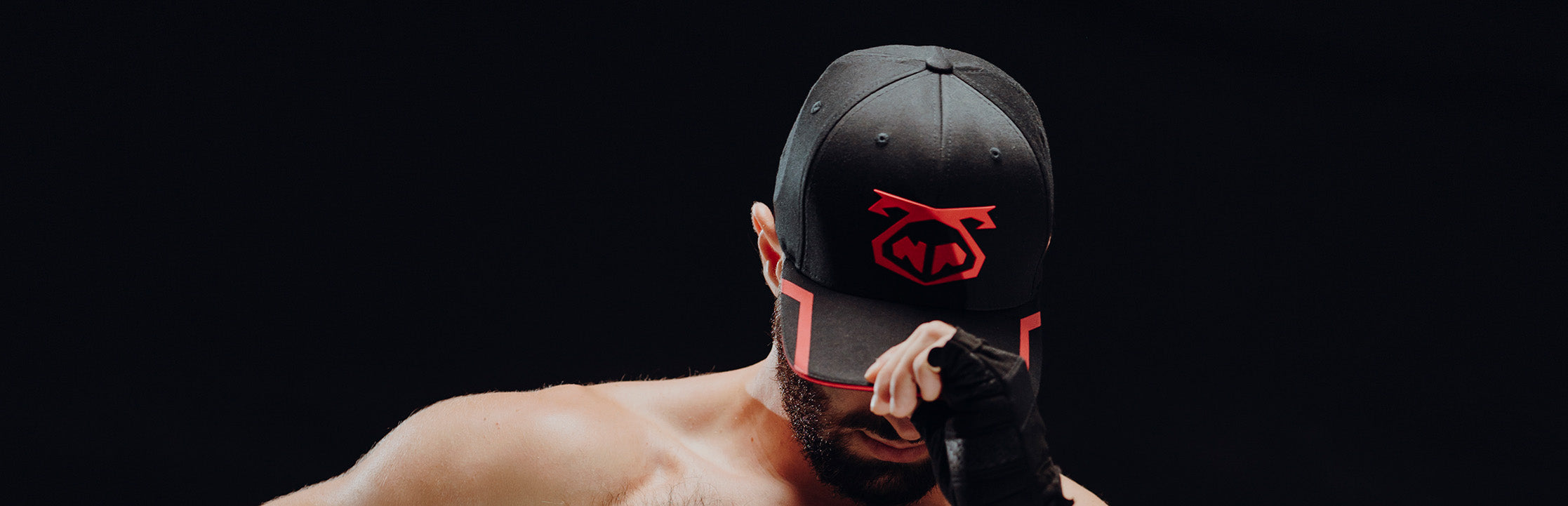 Two men wearing Snout Caps and kissing