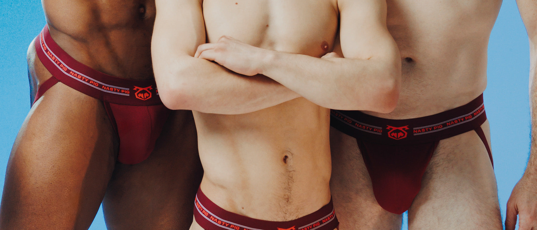 Male model leaning back on boat wearing green jockstrap