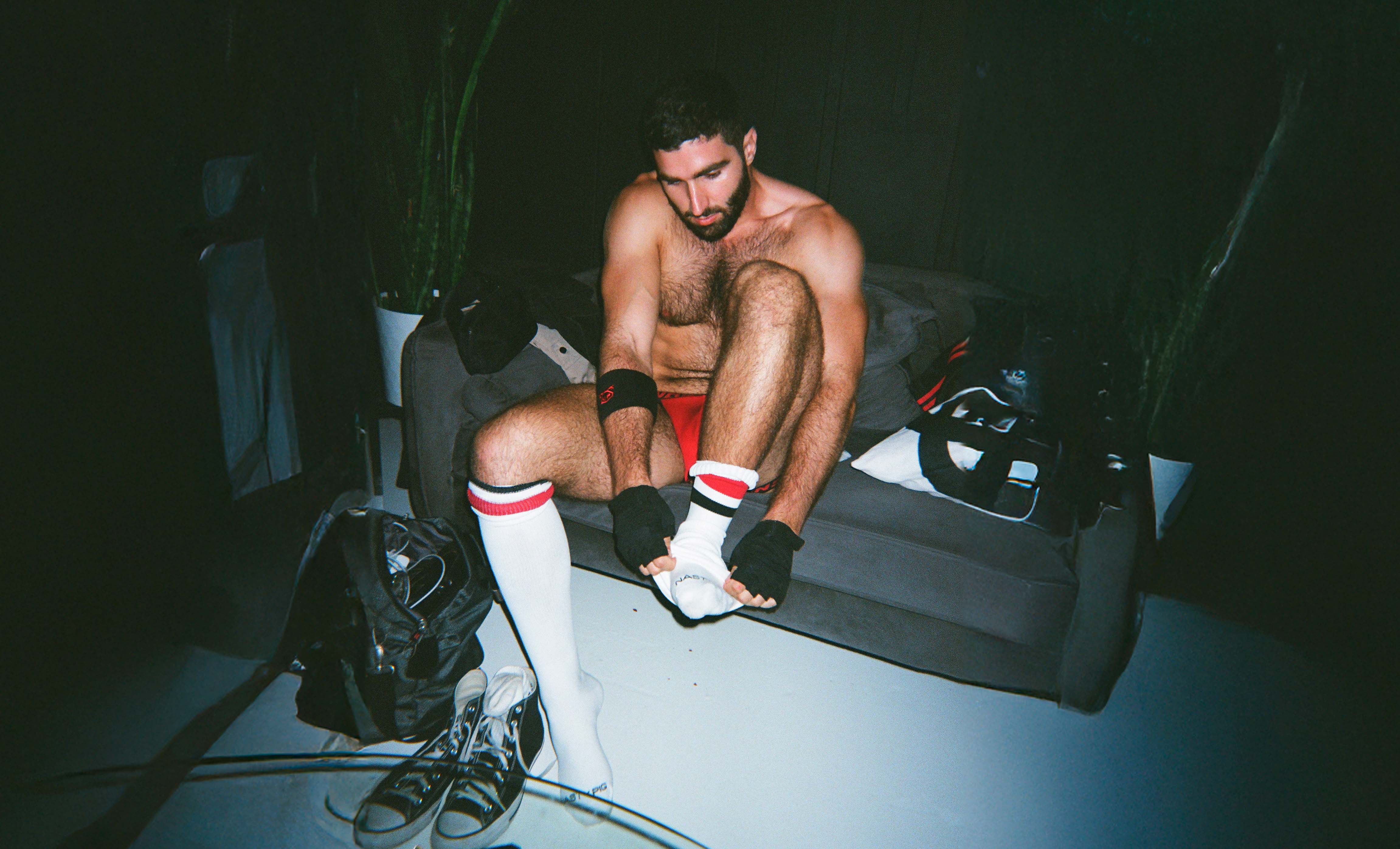 Man wearing Nasty Pig socks in Black/White and boots