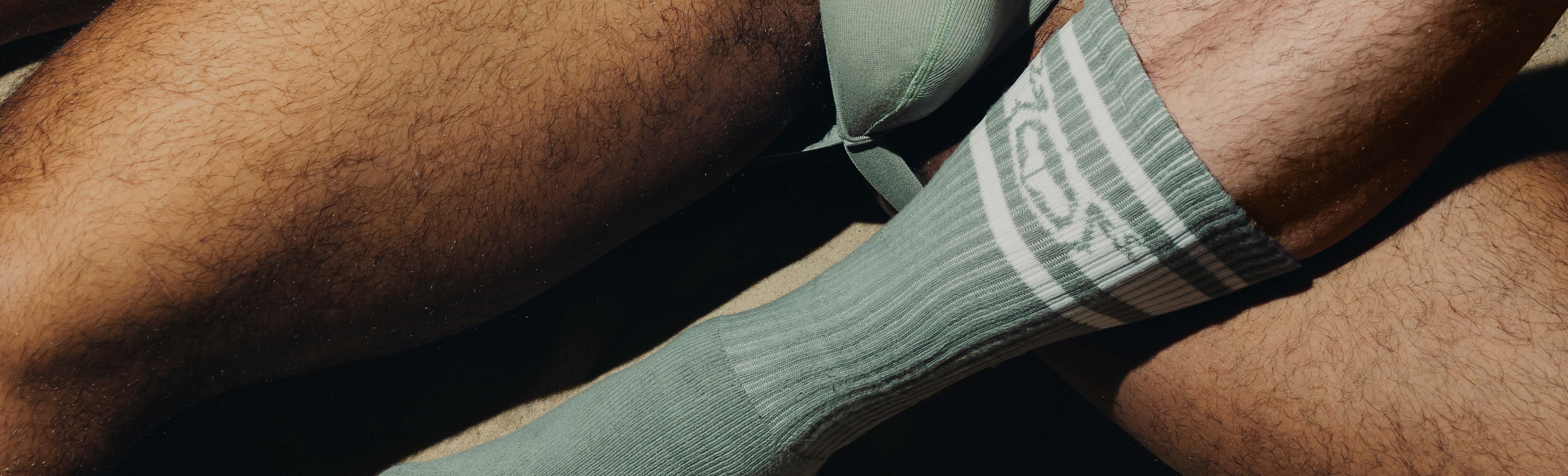 Man wearing Nasty Pig socks in Black/White and boots