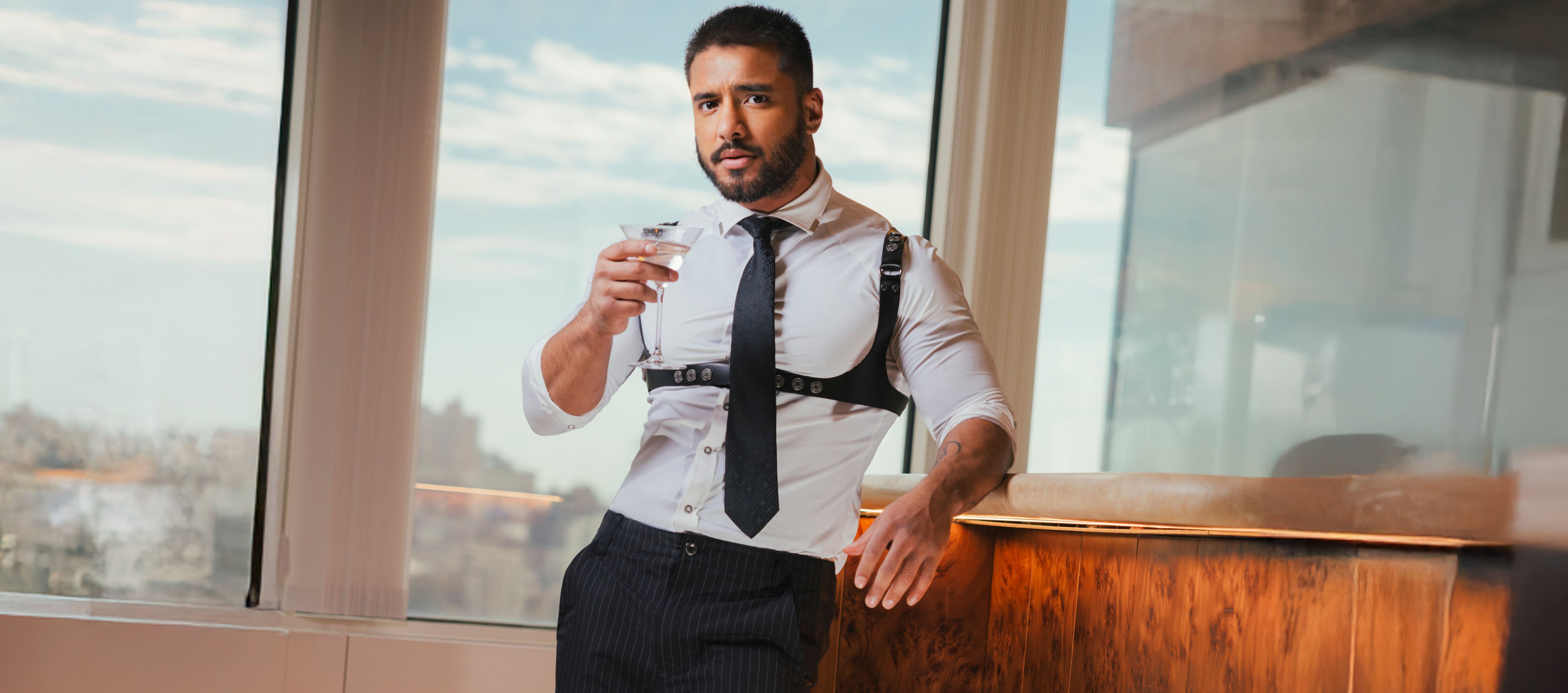 Two men embracing while wearing tank tops