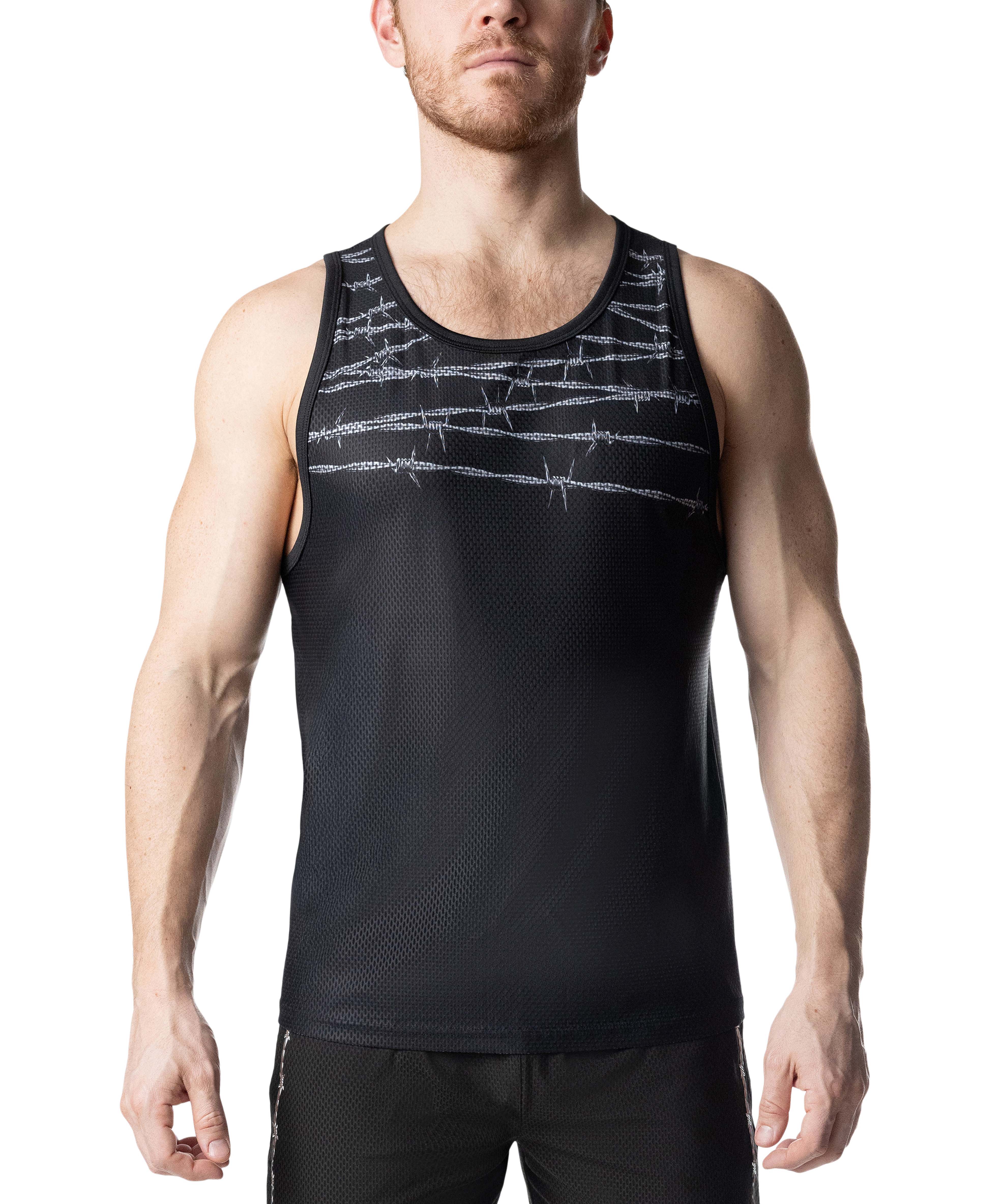 Man wearing a black tank top with barbed wire design on a white background