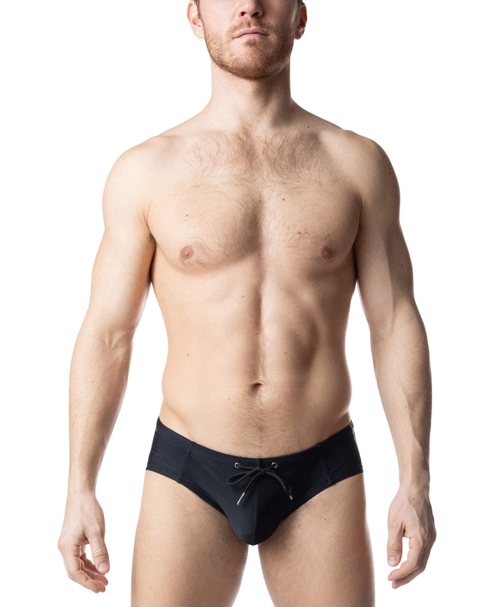 Man wearing black swim briefs on a white background