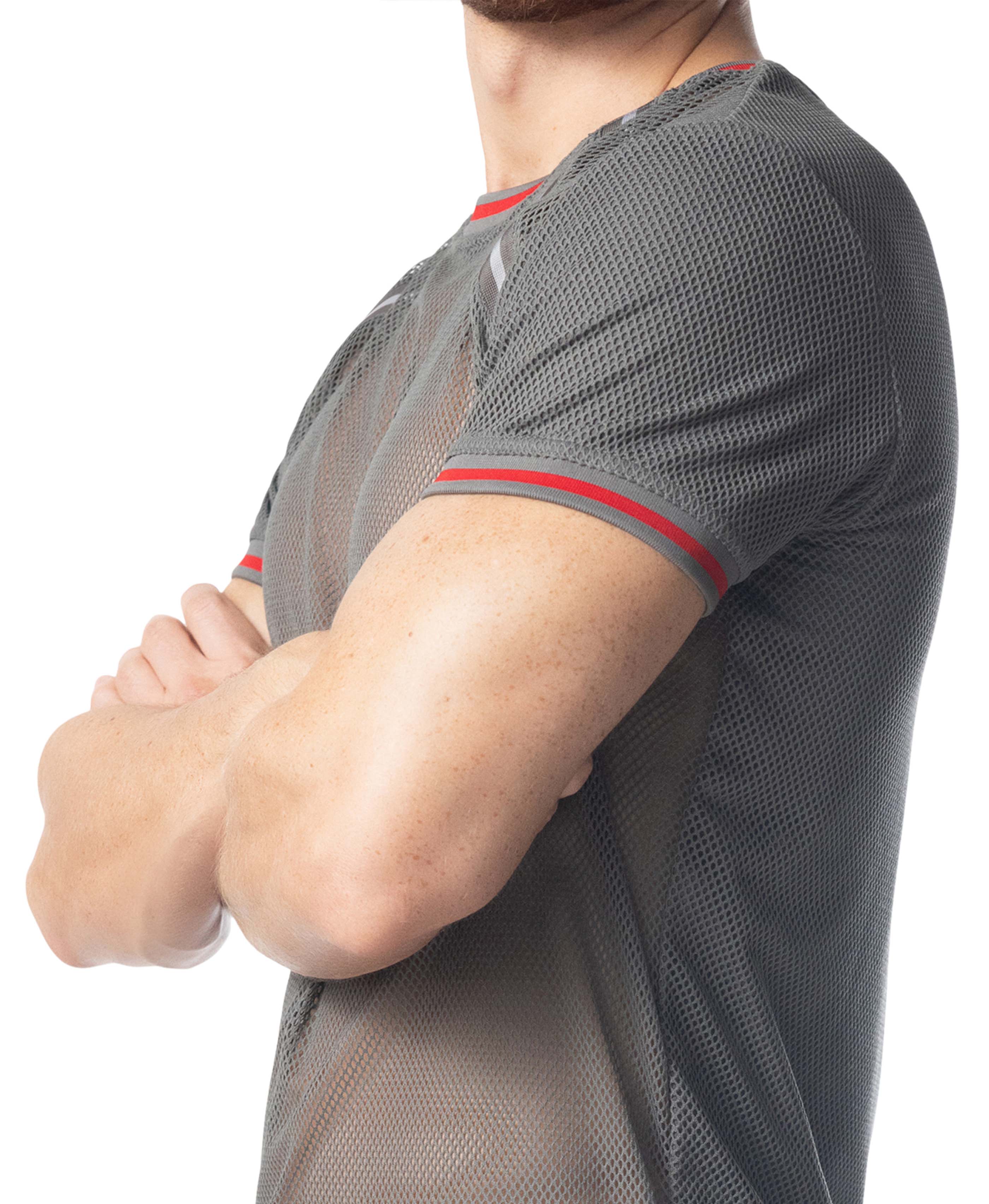 Person wearing a gray mesh shirt with red accents on a white background