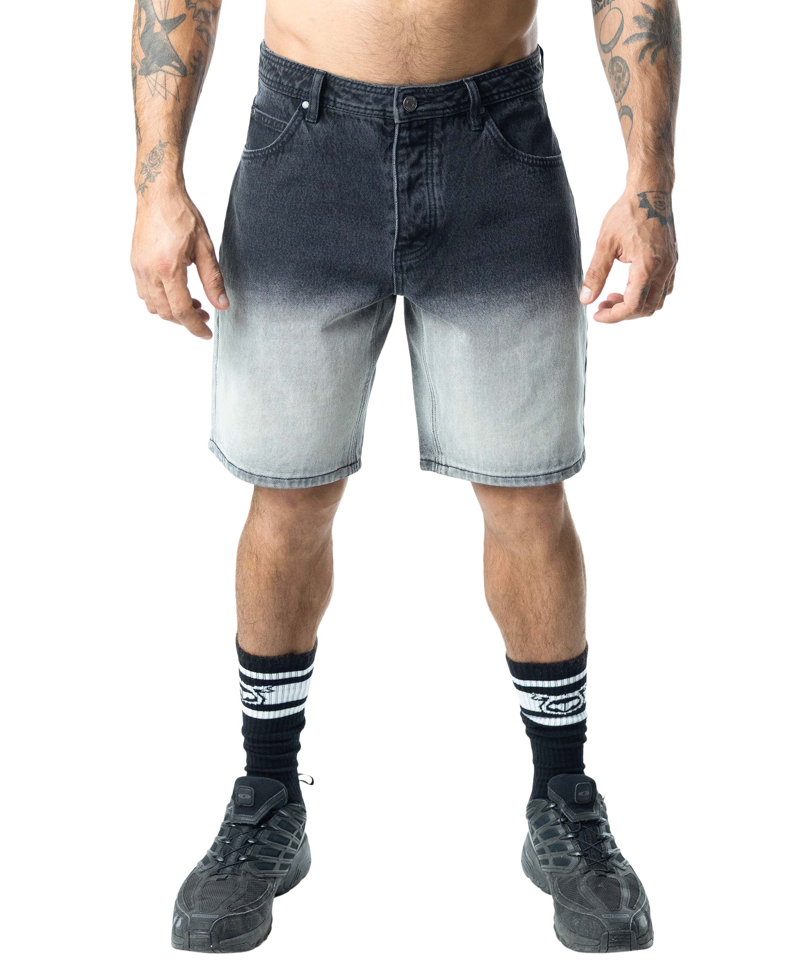 Person wearing black and gray gradient shorts on a white background