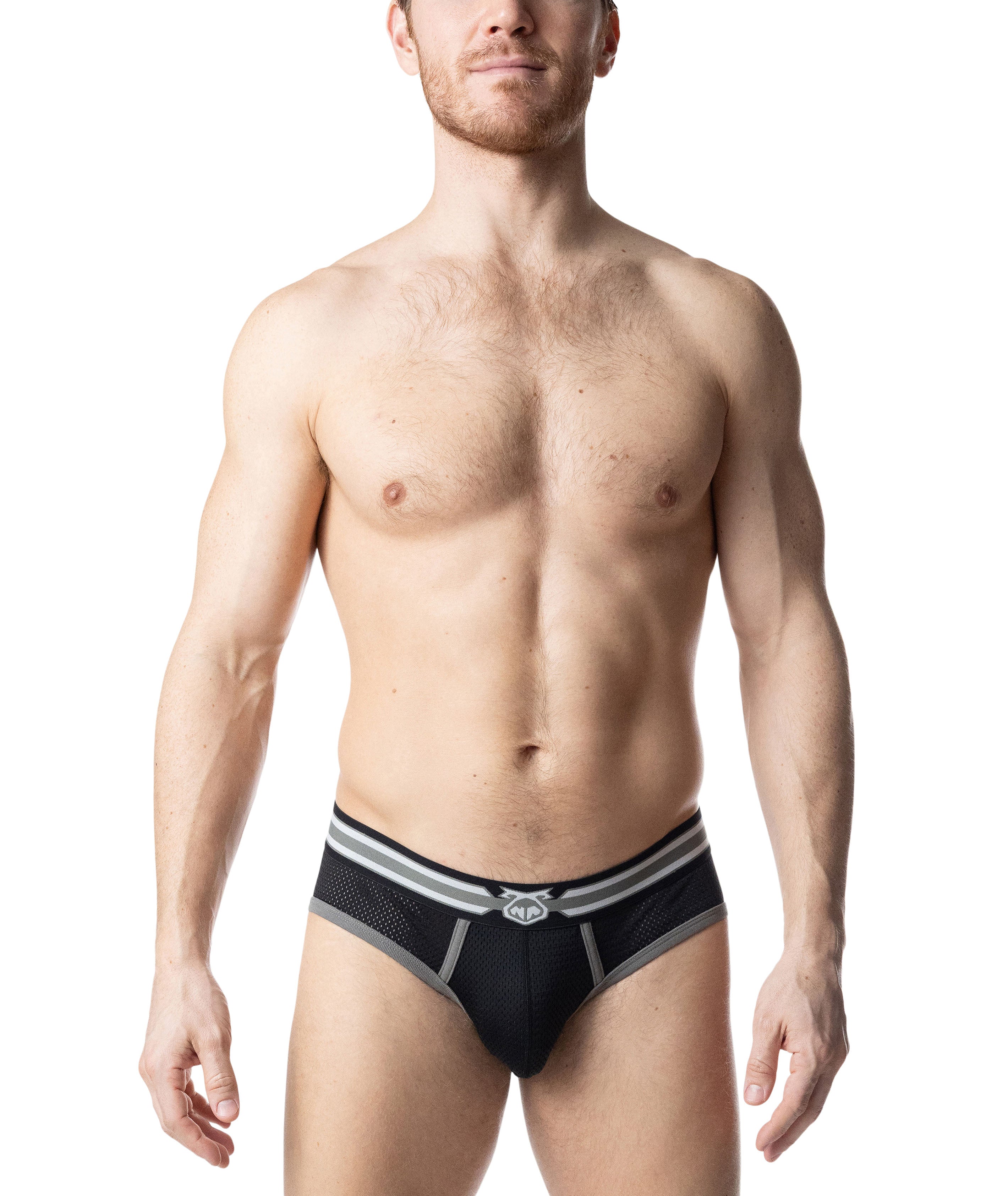 Male model wearing black mesh underwear against a white background.