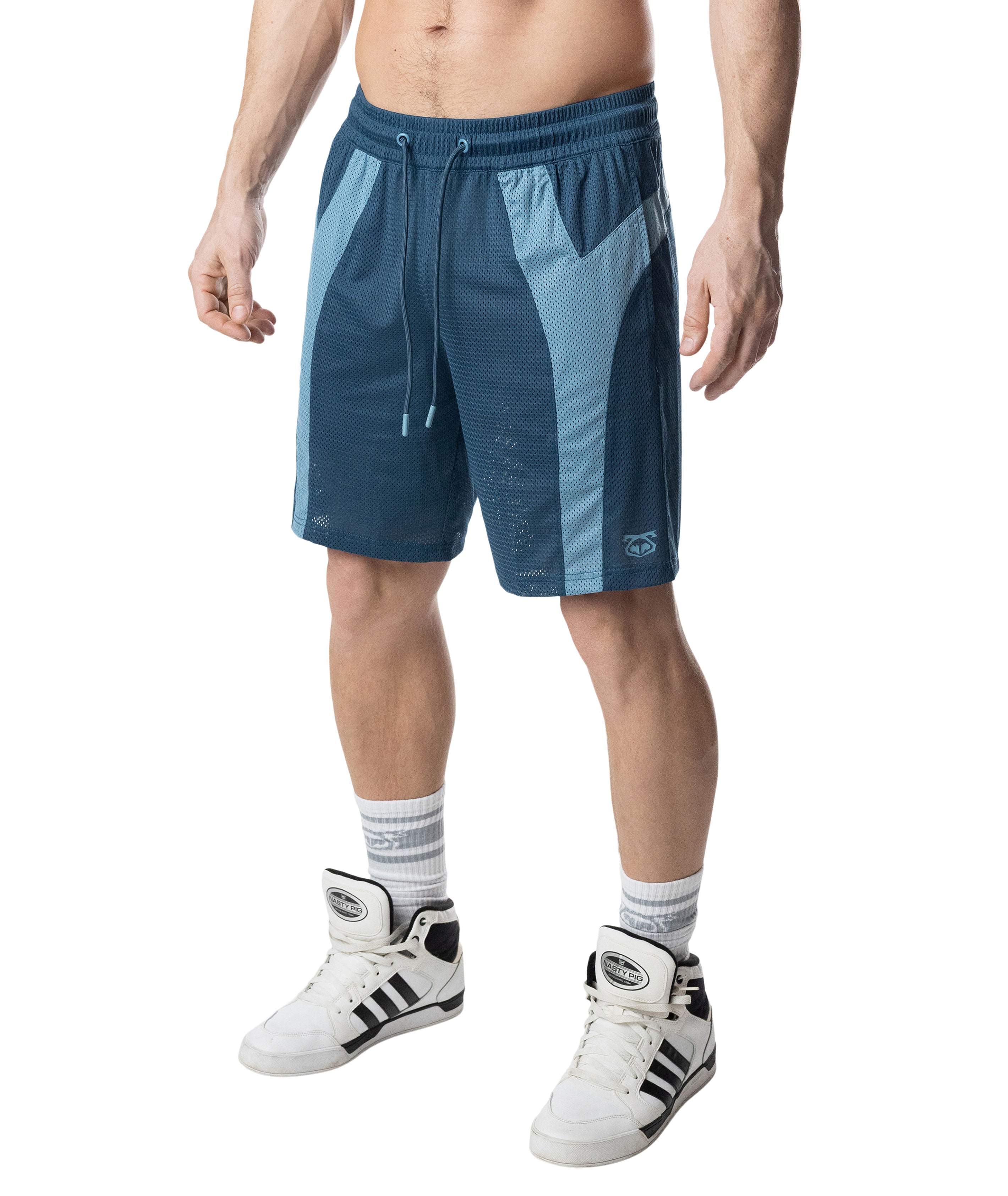 Person wearing blue athletic shorts with white sneakers on a white background