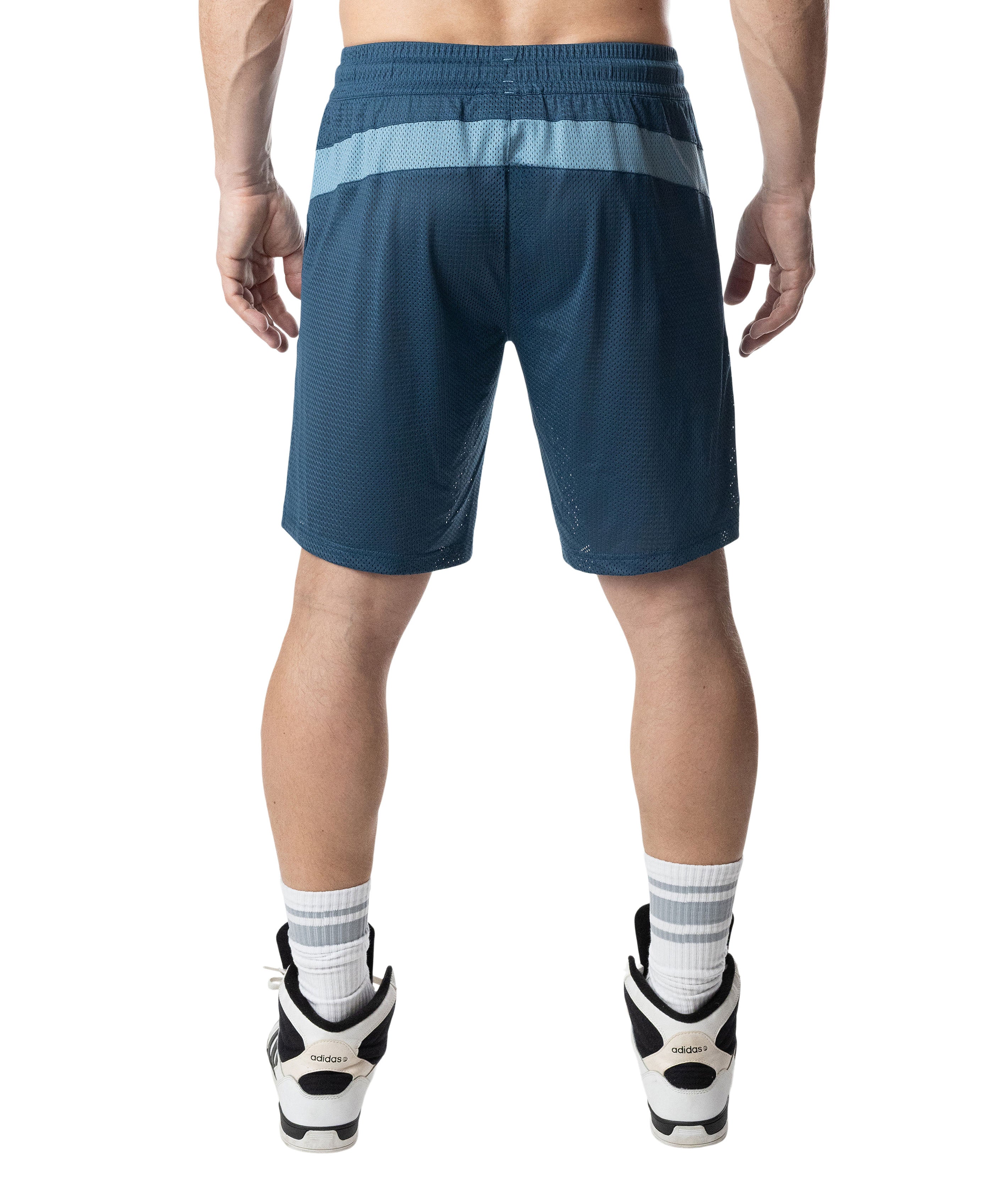 Person wearing blue athletic shorts on a white background