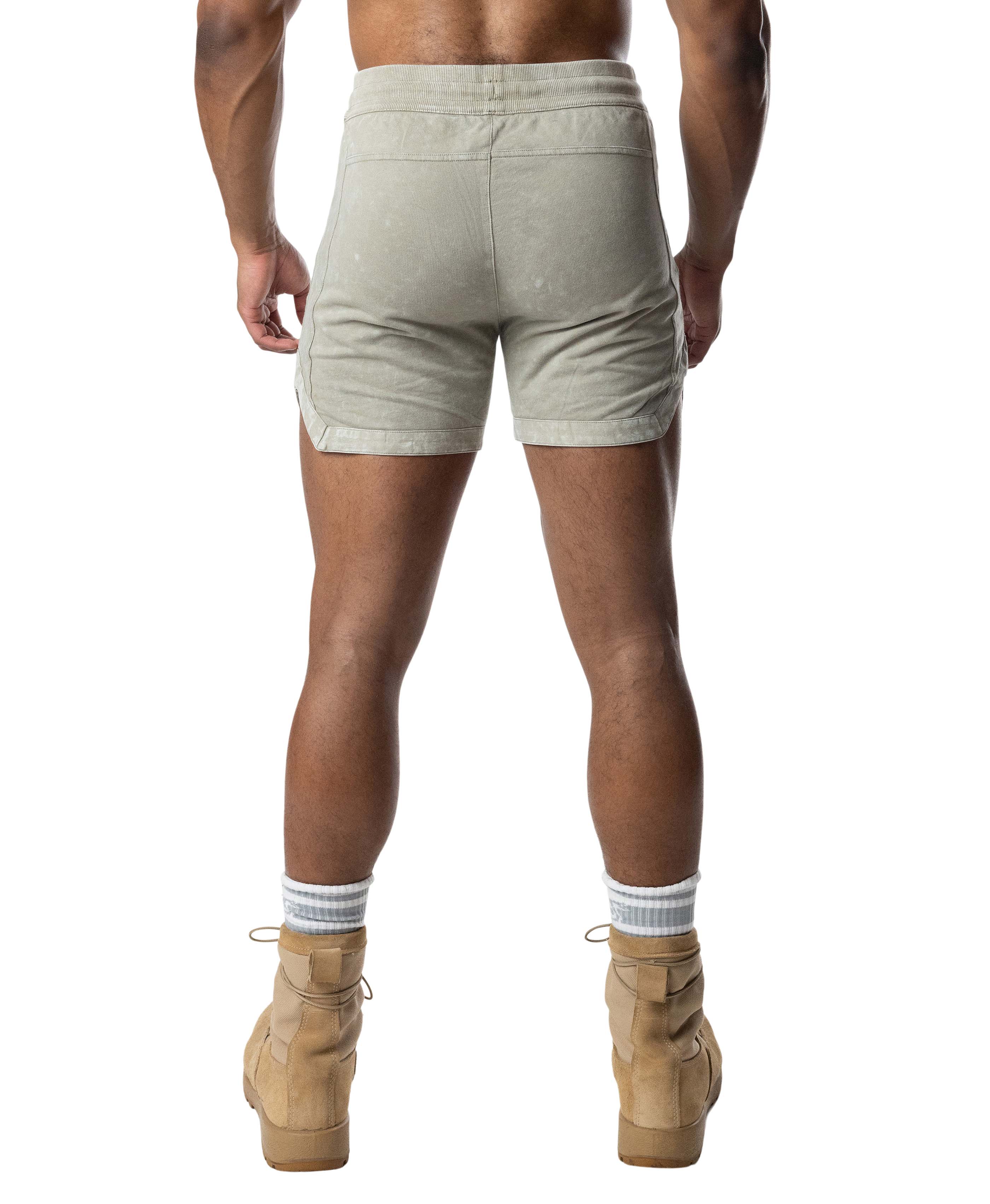 Person wearing green shorts on a white background
