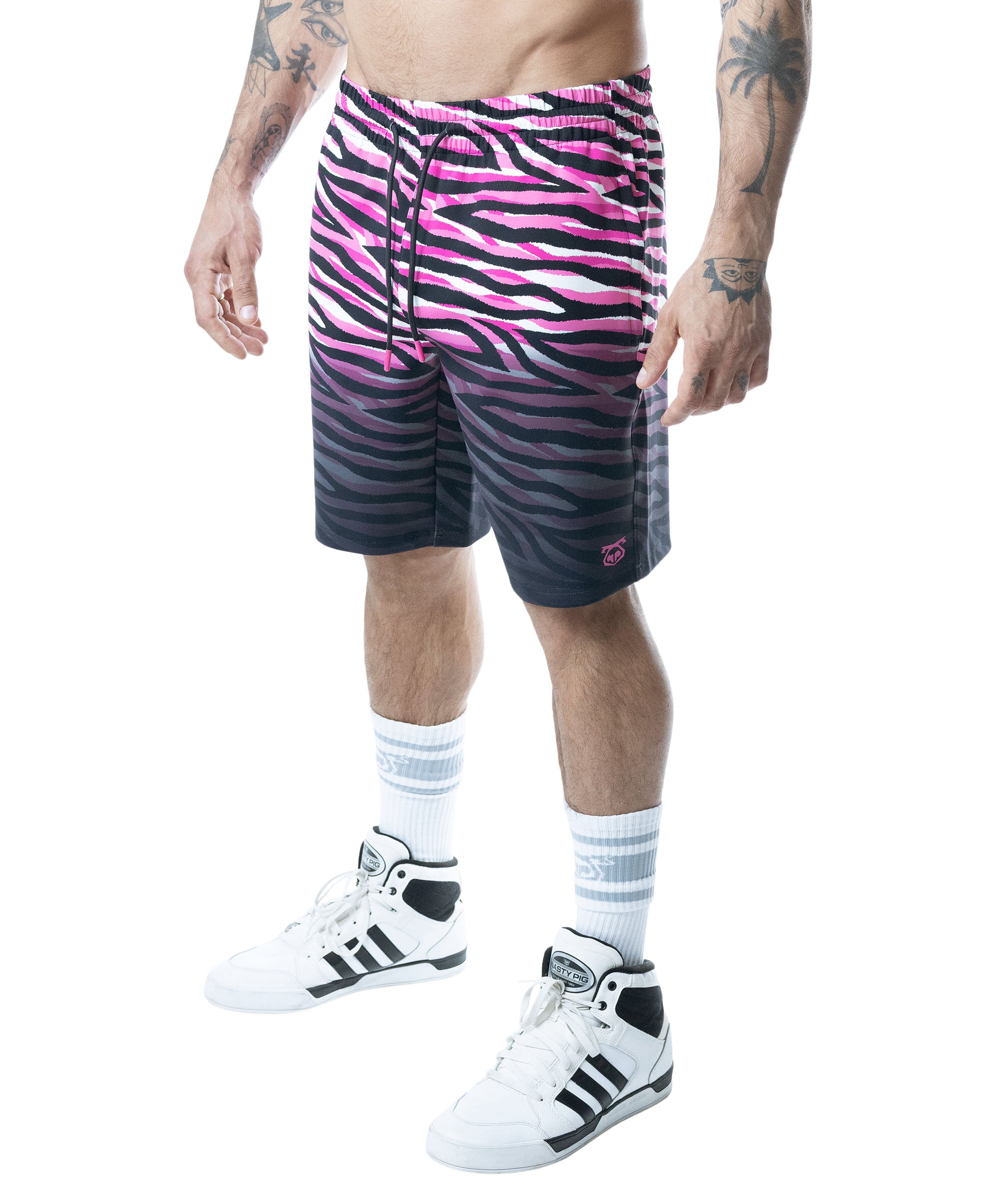 Person wearing pink and black zebra-striped shorts on a white background